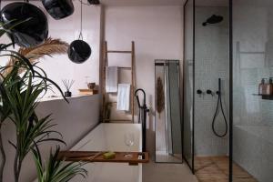a bathroom with a shower and a toilet and a sink at Kynthia Hotel - Adults Only in Kalogria