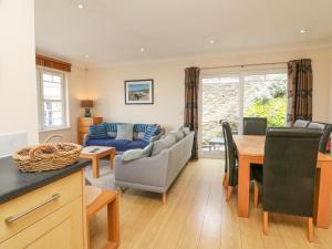 a kitchen and living room with a couch and a table at Beach Lodge in Woolacombe