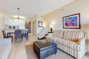 a living room with a couch and a dining room at Caribbean Unit 602 in Gulf Shores