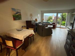 a living room with a table and a couch at La maison du lac in Lutry