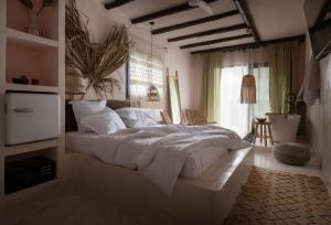 a bedroom with a large bed and a window at Kynthia Hotel - Adults Only in Kalogria