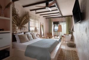 a bedroom with a large bed in a room at Kynthia Hotel - Adults Only in Kalogria