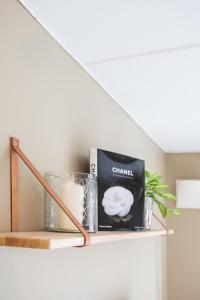 een plank met een boek en andere items erop bij Ultracentral duplex with private rooftop terrace in Oslo