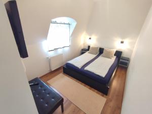 1 dormitorio pequeño con 1 cama y 1 silla en Pelso Apartments, en Siófok