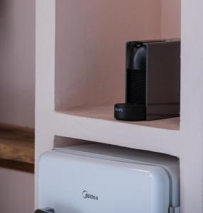 a black appliance sitting on top of a refrigerator at Kynthia Hotel - Adults Only in Kalogria