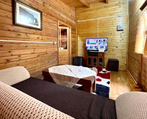 een woonkamer met een tafel en een televisie bij Uji i Panjes Llogara in Vlorë