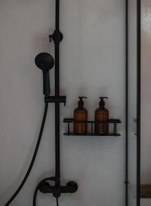 two pots on a shelf in a room at Kynthia Hotel - Adults Only in Kalogria