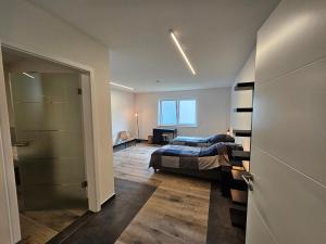 a bedroom with a bed and a room with a door at RSR Nürburg Apartment in Herresbach