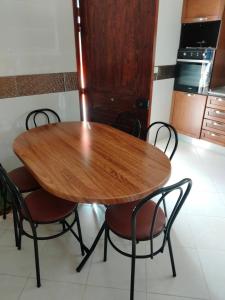 a wooden table and chairs in a kitchen at Dar Zohra in Tabarka