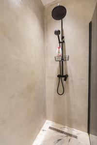 a shower in a bathroom with a shower head at Cosmo Comfort in Tirana