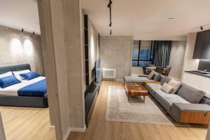 a living room with a bed and a couch at Cosmo Comfort in Tirana