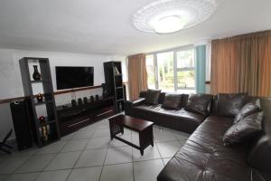 a living room with a couch and a television at Boulevard 14 in Margate