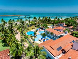 an aerial view of a resort with a pool and the ocean at Baía Branca Beach Resort in Tamandaré