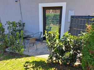 a patio with a table and a table and a chair at Apartament Forest in Radków