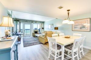a kitchen and living room with a table and chairs at Emerald Dreams Lakefront PCB Vacation Rental! in Panama City Beach