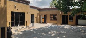 an outside view of a building with its doors open at Royal Home Guesthouse in Maun