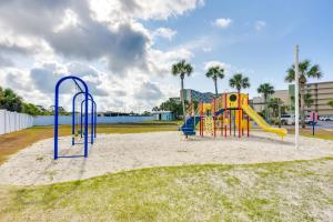 a playground with a slide in the sand at Emerald Dreams Lakefront PCB Vacation Rental! in Panama City Beach
