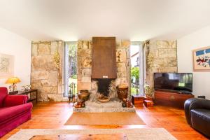 uma sala de estar com um sofá vermelho e uma lareira em Portugal Active Oliveiras Farm em Viana do Castelo