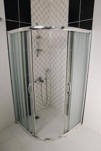 a shower with a glass door in a bathroom at Yıldız Villa in Alanya
