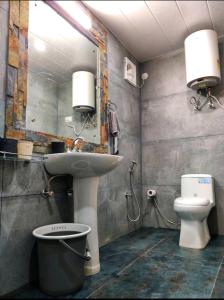 a bathroom with a sink and a toilet at Lacasa Luxury Stays in Shogi