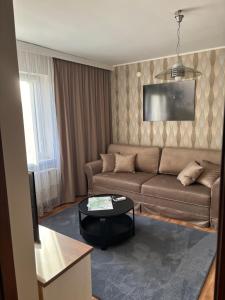 a living room with a couch and a table at Raj z haczykiem in Grzmięca