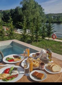 a table with plates of food and drinks on it at Villa Teverde in Shkodër