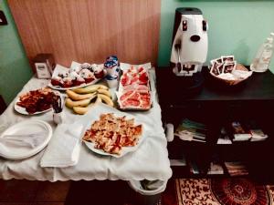 a table with plates of food and a dog on it at FLORIDA B&B Cingoli in Cingoli