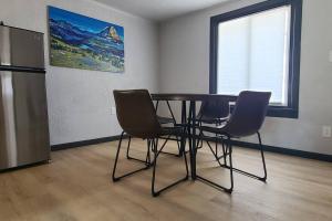 a dining room with a table and two chairs at The Northern Lights Cottage in Columbia Falls +19 photos