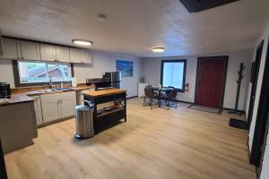 an empty kitchen and living room with a table at The Northern Lights Cottage in Columbia Falls