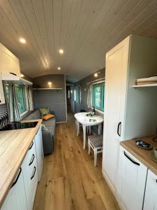 a kitchen and living room of a tiny house at La Bohème in Merendree +19 photos