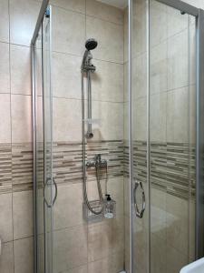 a bathroom with a shower with a glass door at Mini-hotel Casa de la Luz in Alicante +70 photos