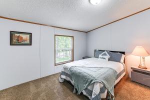 a bedroom with a bed and a window at Kuttawa Vacation Rental with Smart TV, Near Marinas! in Kuttawa