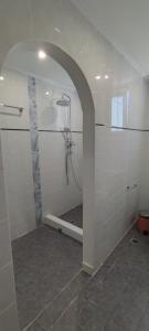 a white bathroom with a shower with a sink at Chrysiis House 2 in Analipsi
