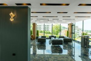 a conference room with black chairs and large windows at Air Barbaros Hotel Trabzon in Trabzon