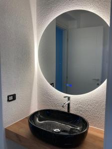 a bathroom with a black sink in front of a mirror at Il Cirmolo Santa Maria Maggiore Locazione Turistica in Santa Maria Maggiore +28 photos