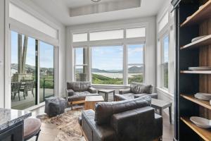 a living room with a couch and chairs and windows at Deer Springs 12797 by Moose Management in Park City