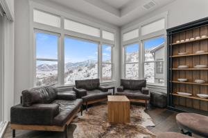 a living room with couches and chairs and windows at Deer Springs 12797 by Moose Management in Park City