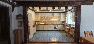 a kitchen with white cabinets and a blue tile floor at Chata Lisiczka in Piwniczna-Zdroj