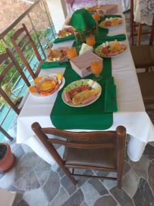 a long table with plates of food on it at Guest House Bumbli in Berat