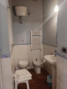 ein weißes Bad mit einem WC und einem Waschbecken in der Unterkunft Angelini in Lucca