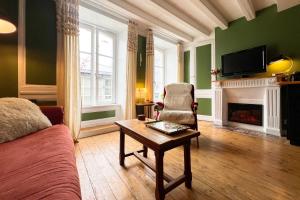 a living room with a couch and a table at Appart de charme, 2 chambres en centre ville in Cherbourg en Cotentin