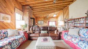 a living room with two couches and a table at Big Family Lodge near ARK Sleeps 16 in Williamstown