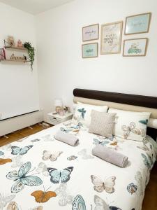 a bedroom with a bed with butterflies on it at Apartment Atria in Vrnjačka Banja