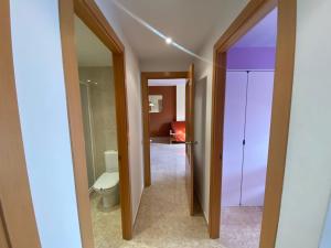 a bathroom with a toilet and a door to a room at Apartamento Cinca Pirineo en Aínsa in Aínsa +47 photos