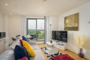 a living room with a couch and a large window at Charming 1-Bed Apartment in Leeds in Leeds