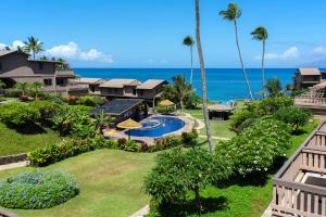 an aerial view of a resort with a swimming pool and the ocean at Oceanfront & ac! ks d9 - Sullivan Properties in Kahana