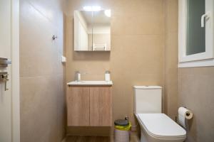 a small bathroom with a toilet and a sink at Ilisia 2 person apartment by MPS in Athens +6 photos
