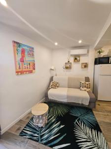 a small room with a bed and a refrigerator at Duplex dans maison de village in Cagnes-sur-Mer