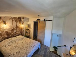 a bedroom with a bed and a sliding door at Duplex dans maison de village in Cagnes-sur-Mer