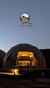 a large building with a sign on top of it at STAR CAMP & WiTH TOR in Wadi Rum +139 photos